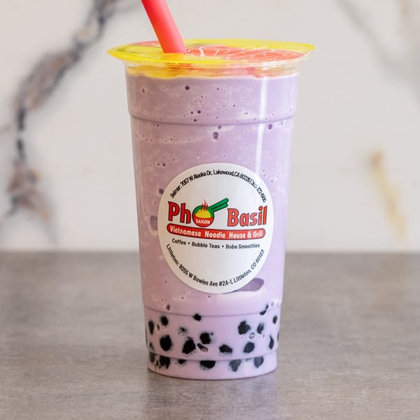 A purple taro boba smoothie with a red straw and Pho Saigon Basil label.
